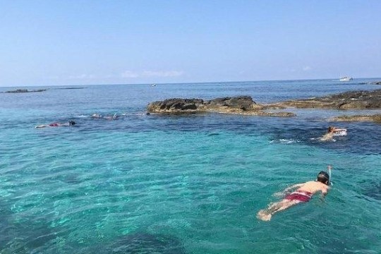 a man swimming in the ocean